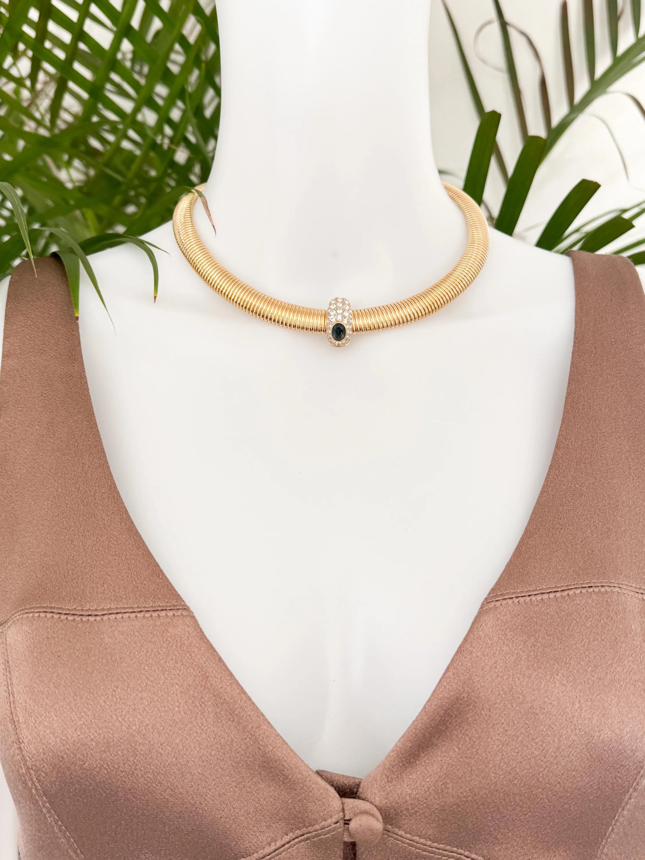 Vintage Nina Ricci Tubogas choker necklace in gold tone with sapphire-blue and clear crystals, elegant 1980s-style designer jewelry.