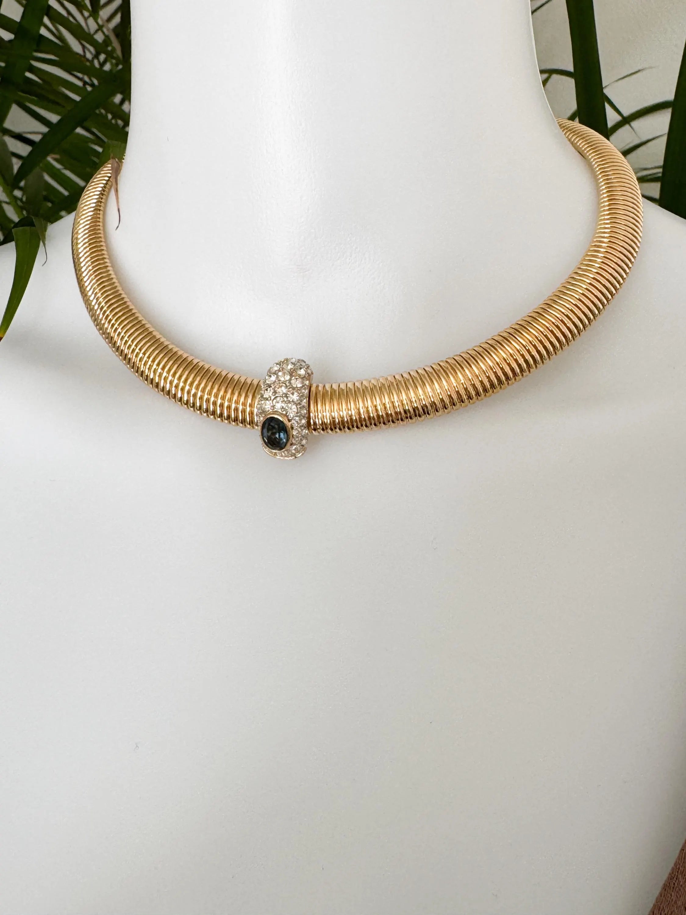 Vintage Nina Ricci Tubogas choker necklace in gold tone with sapphire-blue and clear crystals, elegant 1980s-style designer jewelry.