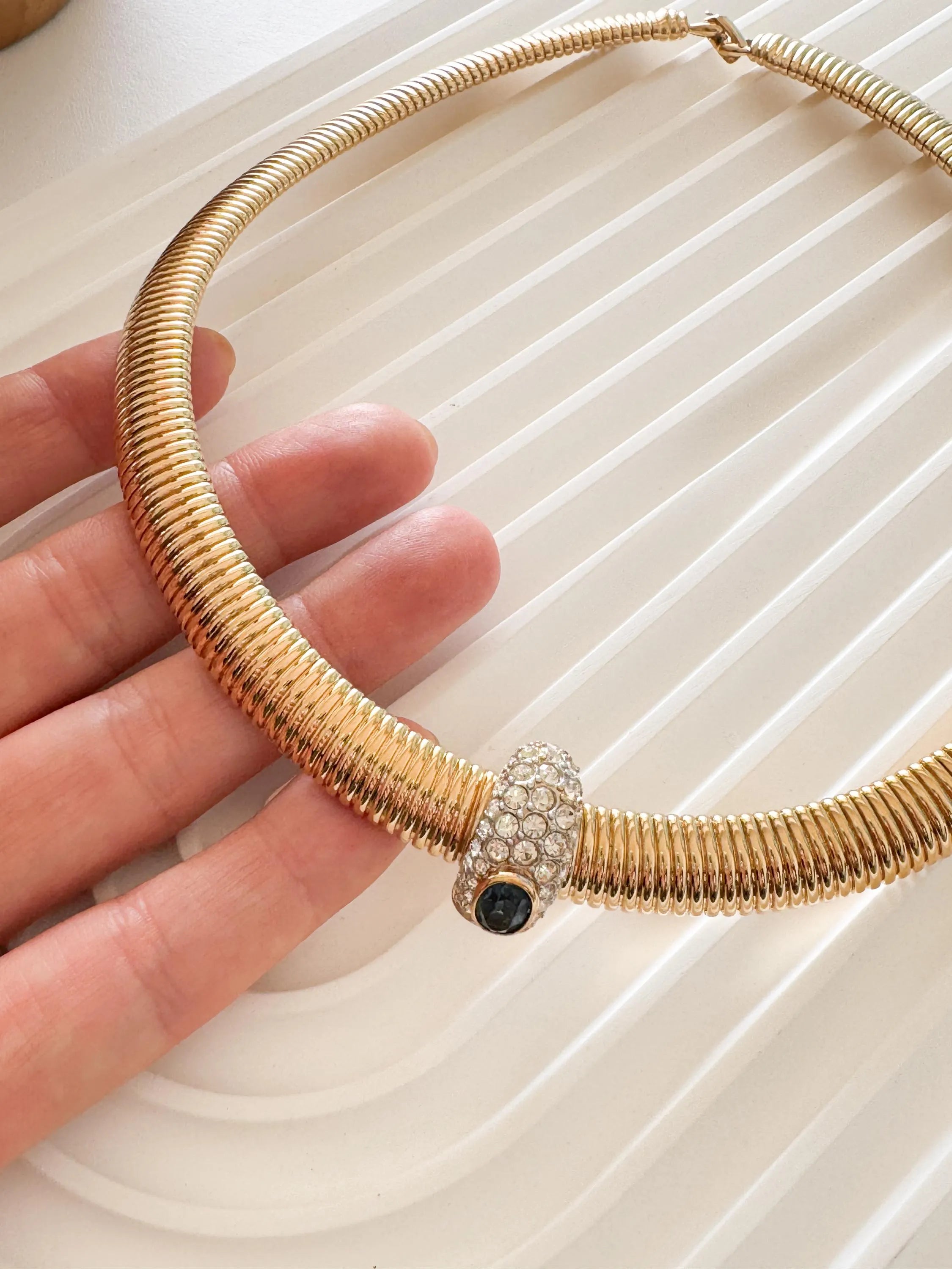 Vintage Nina Ricci Tubogas choker necklace in gold tone with sapphire-blue and clear crystals, elegant 1980s-style designer jewelry.