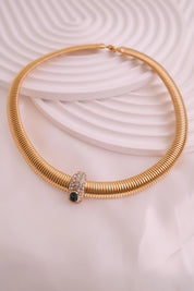 Vintage Nina Ricci Tubogas choker necklace in gold tone with sapphire-blue and clear crystals, elegant 1980s-style designer jewelry.