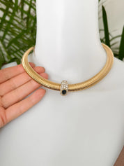 Vintage Nina Ricci Tubogas choker necklace in gold tone with sapphire-blue and clear crystals, elegant 1980s-style designer jewelry.