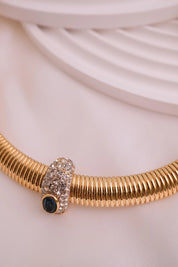 Vintage Nina Ricci Tubogas choker necklace in gold tone with sapphire-blue and clear crystals, elegant 1980s-style designer jewelry.