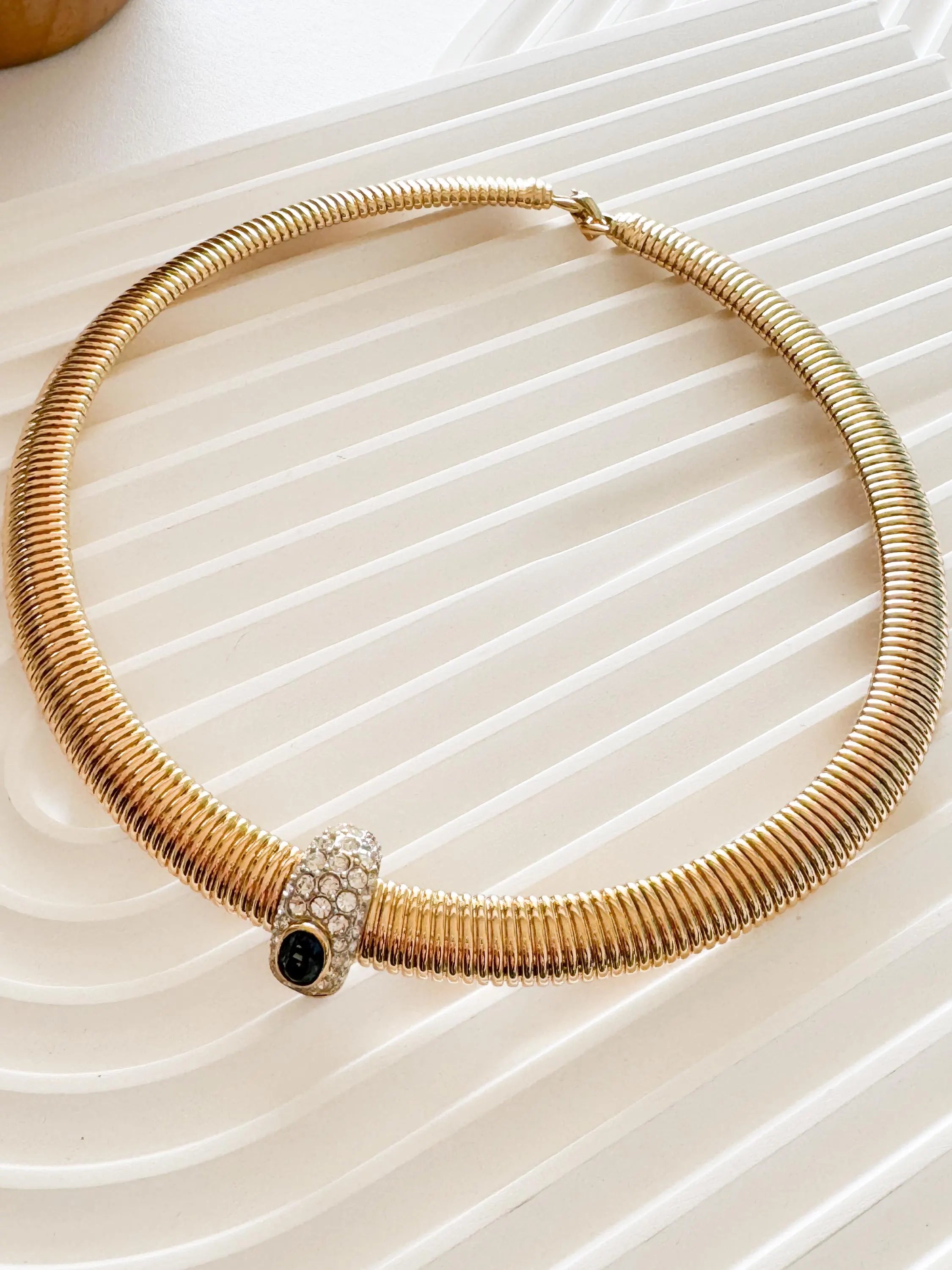 Vintage Nina Ricci Tubogas choker necklace in gold tone with sapphire-blue and clear crystals, elegant 1980s-style designer jewelry.
