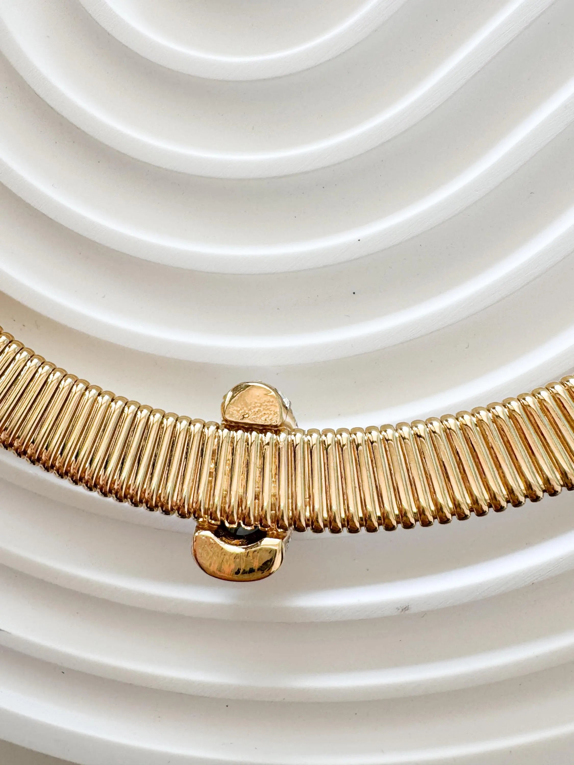 Vintage Nina Ricci Tubogas choker necklace in gold tone with sapphire-blue and clear crystals, elegant 1980s-style designer jewelry.