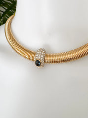 Vintage Nina Ricci Tubogas choker necklace in gold tone with sapphire-blue and clear crystals, elegant 1980s-style designer jewelry.
