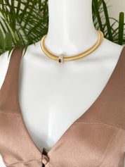 Vintage Nina Ricci Tubogas choker necklace in gold tone with sapphire-blue and clear crystals, elegant 1980s-style designer jewelry.