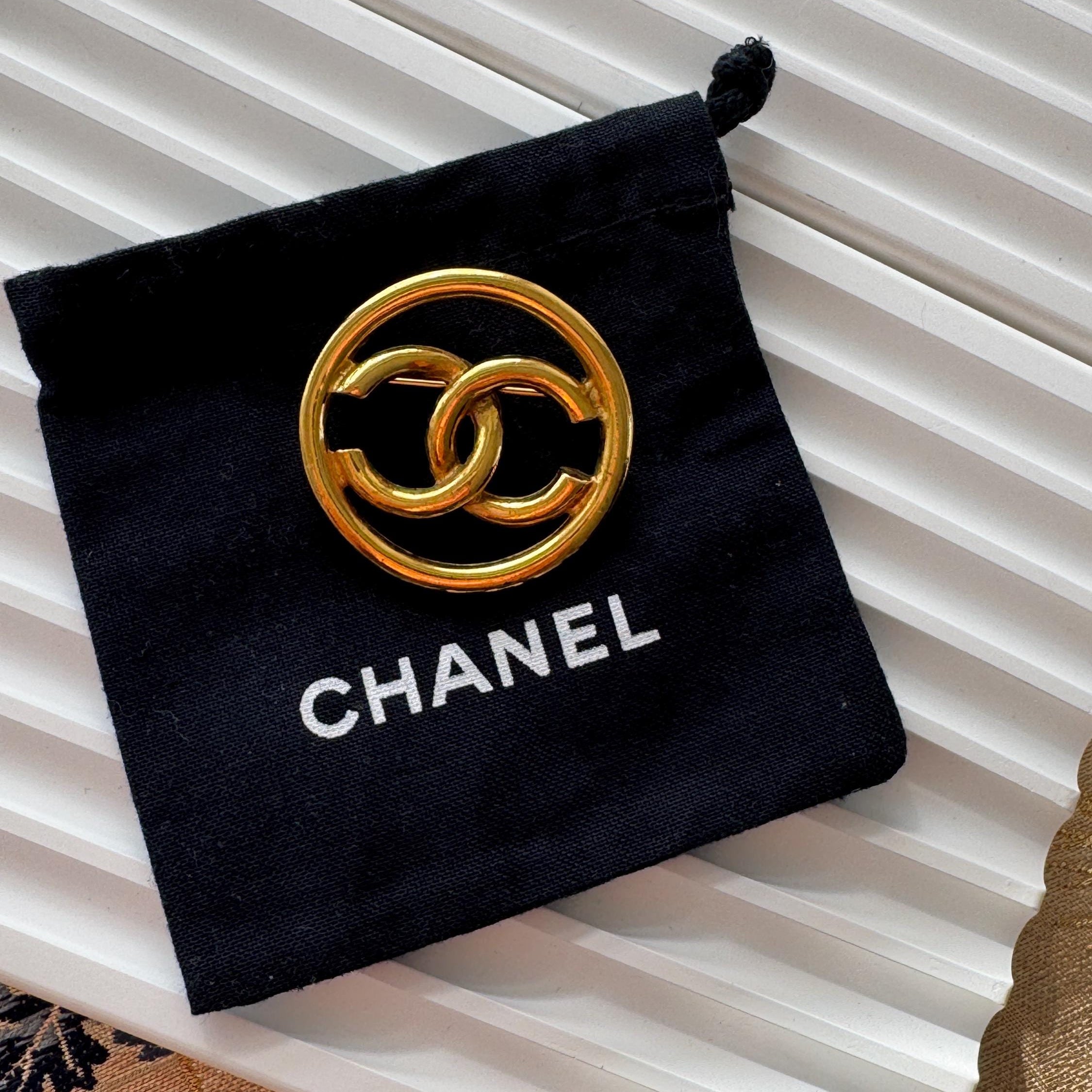 Vintage Chanel gold CC circle brooch, refined Parisian heritage jewelry with timeless elegance