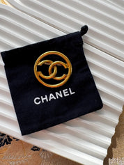 Vintage Chanel gold CC circle brooch, refined Parisian heritage jewelry with timeless elegance