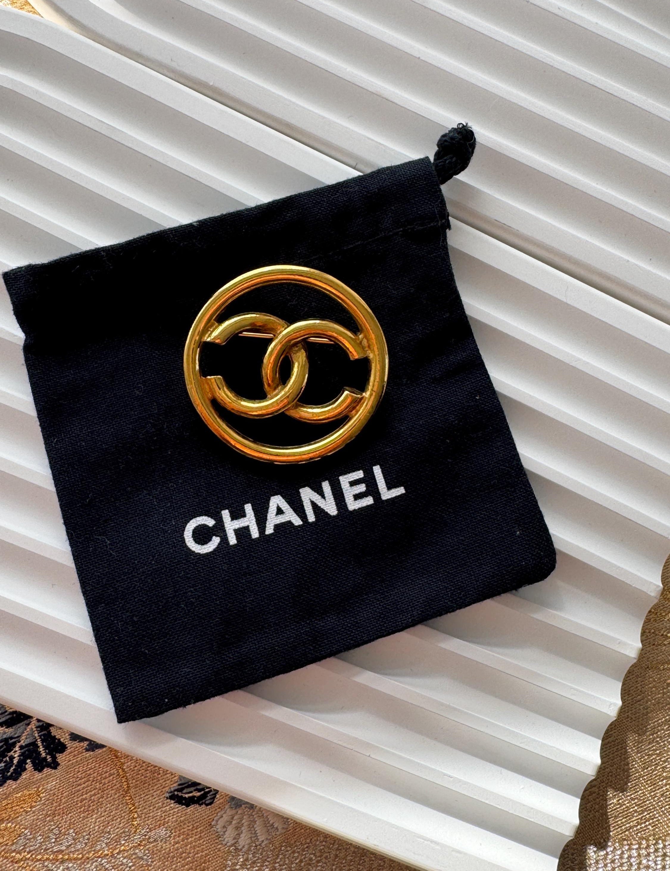 Vintage Chanel gold CC circle brooch, refined Parisian heritage jewelry with timeless elegance