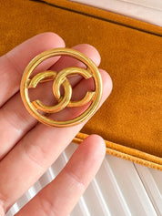 Vintage Chanel gold CC circle brooch, refined Parisian heritage jewelry with timeless elegance