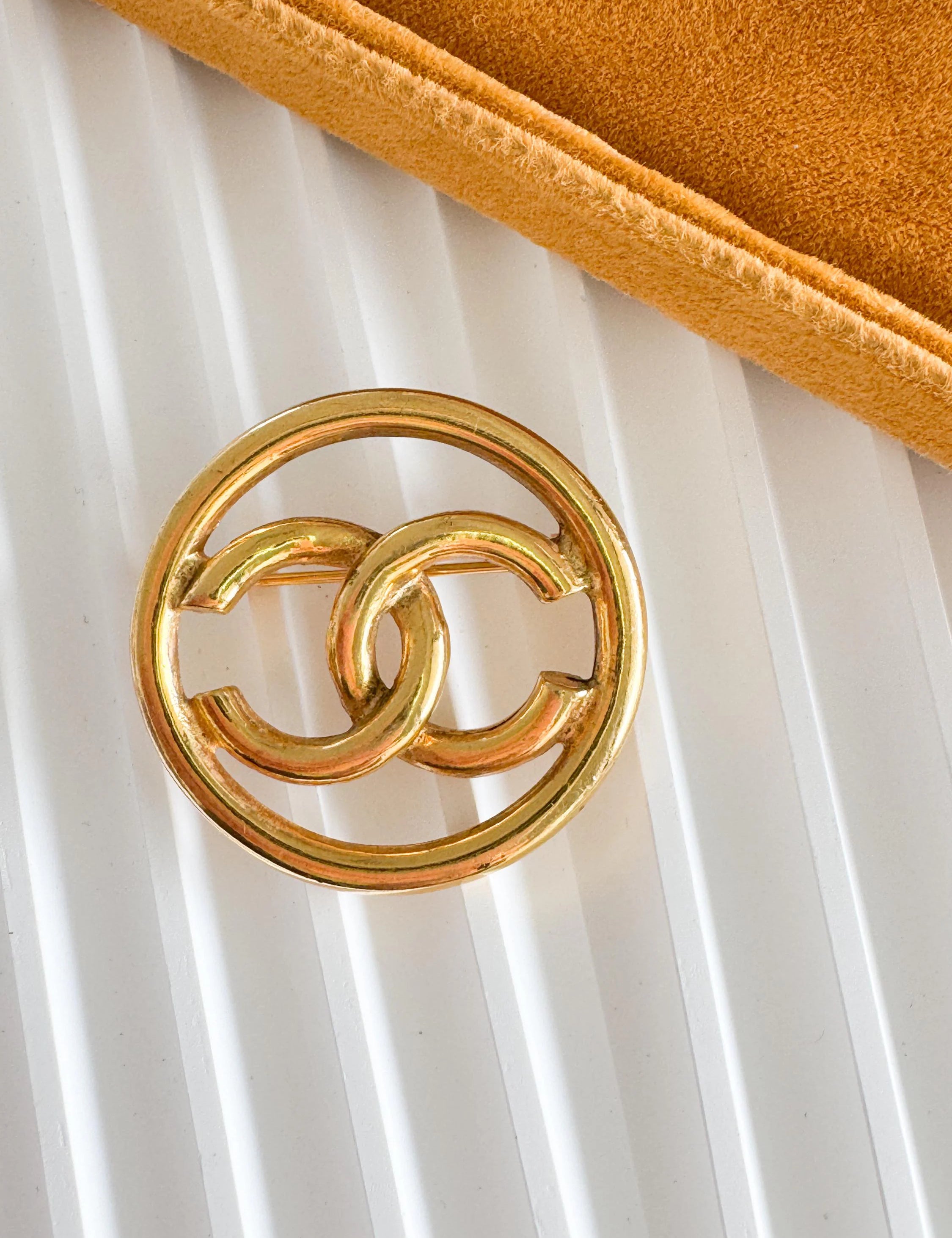 Vintage Chanel gold interlocking CC brooch, understated French luxury accessory