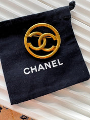 Vintage Chanel gold interlocking CC brooch, understated French luxury accessory