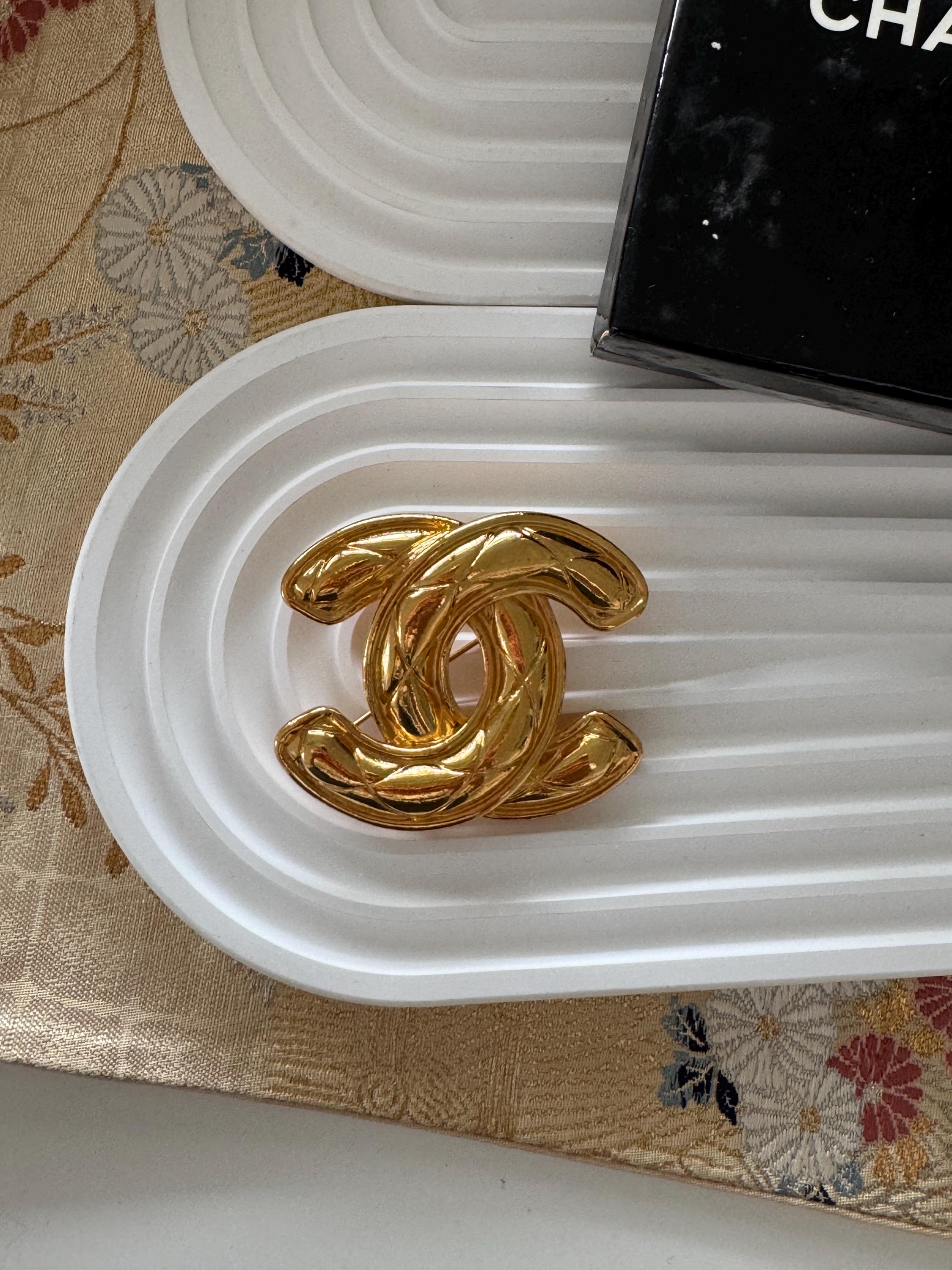 Vintage Chanel gold interlocking CC brooch, refined Paris luxury designer jewelry