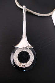 Vintage Christian Dior 1971 pendant reverse showing plating wear