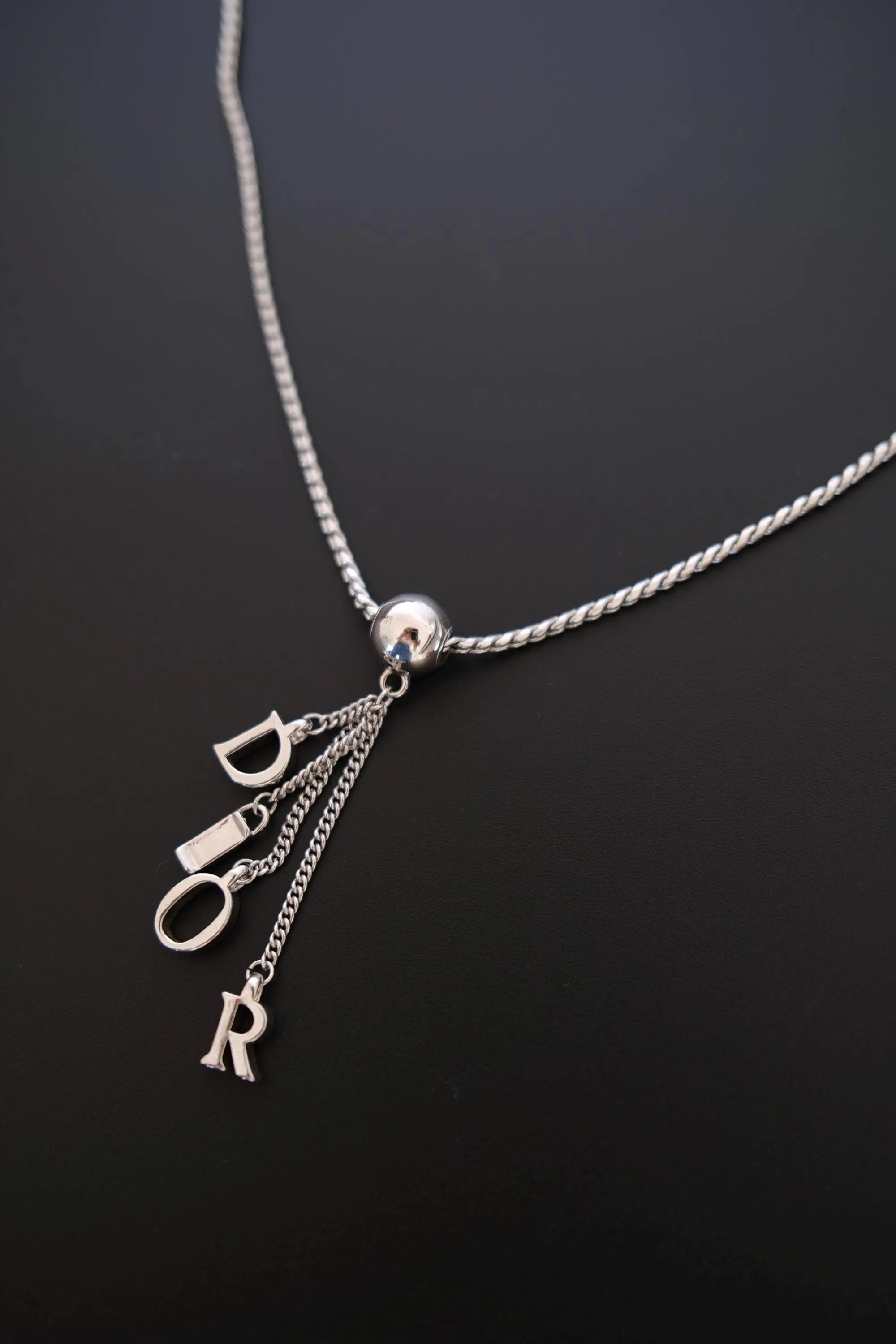 Vintage Dior D-I-O-R individual letter charms hanging from delicate silver-tone chains