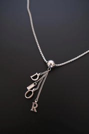 Vintage Dior polished spherical centerpiece and dangling letter tassel detail