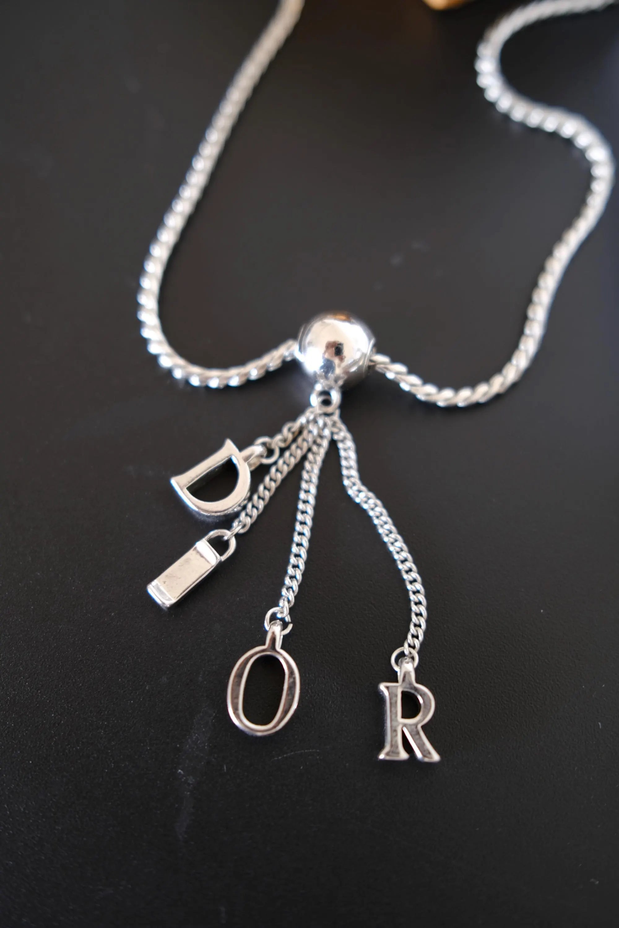 Vintage Dior D-I-O-R individual letter charms hanging from delicate silver-tone chains
