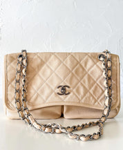 Vintage classic Chanel shoulder bag in caviar beige, made in France, with large front pockets, luxury designer handbag