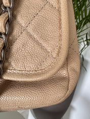 Vintage classic Chanel shoulder bag in caviar beige, made in France, with large front pockets, luxury designer handbag