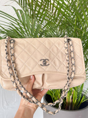 Vintage classic Chanel shoulder bag in caviar beige, made in France, with large front pockets, luxury designer handbag