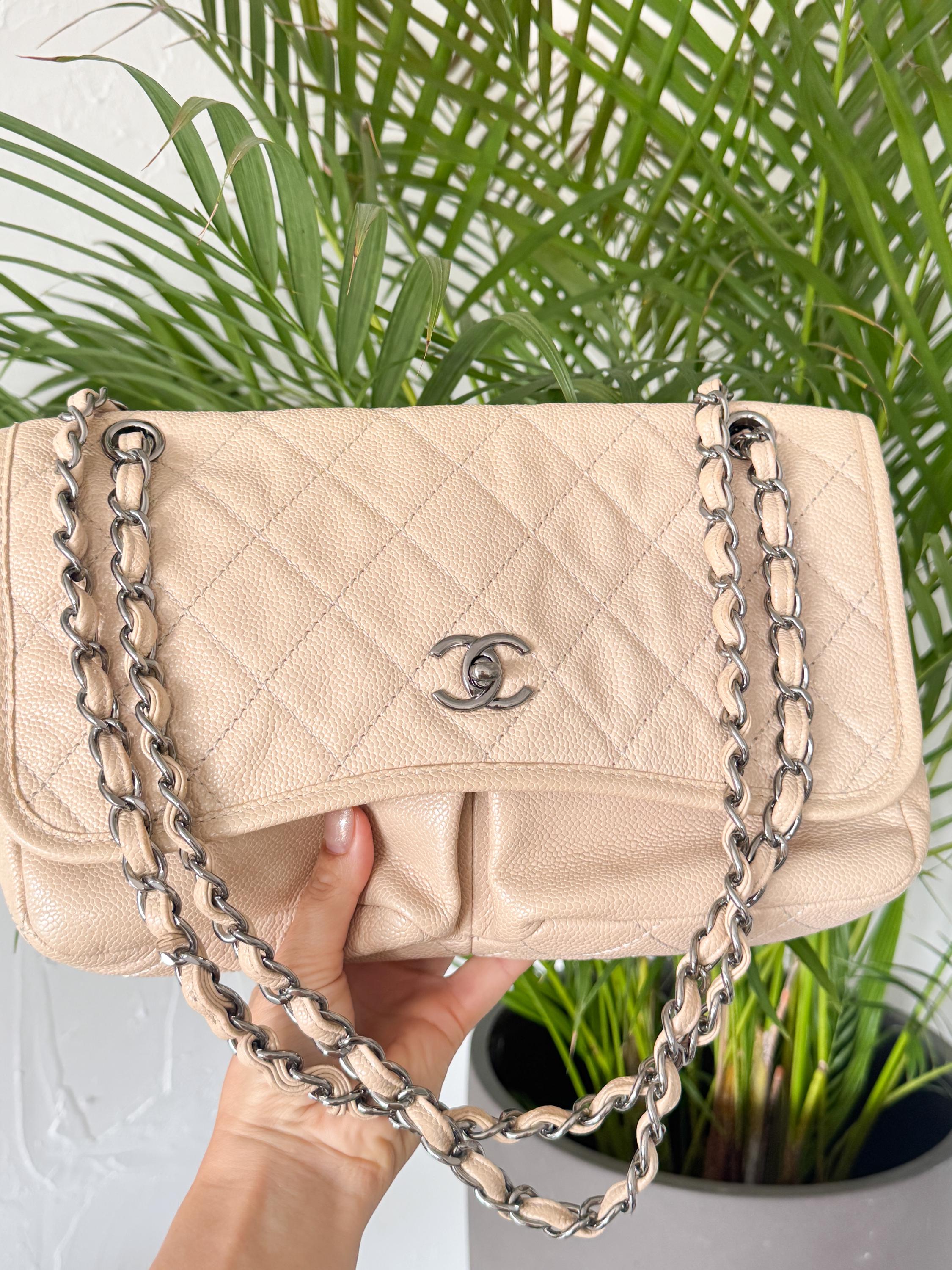 Vintage classic Chanel shoulder bag in caviar beige, made in France, with large front pockets, luxury designer handbag