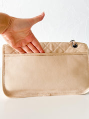 Vintage classic Chanel shoulder bag in caviar beige, made in France, with large front pockets, luxury designer handbag
