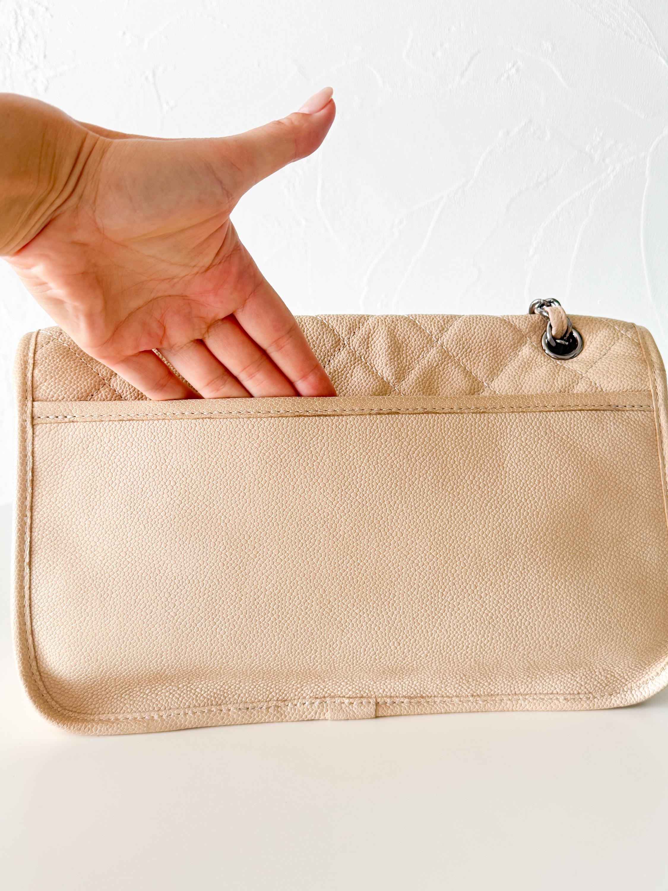 Vintage classic Chanel shoulder bag in caviar beige, made in France, with large front pockets, luxury designer handbag