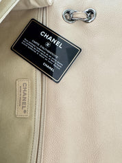 Vintage classic Chanel shoulder bag in caviar beige, made in France, with large front pockets, luxury designer handbag