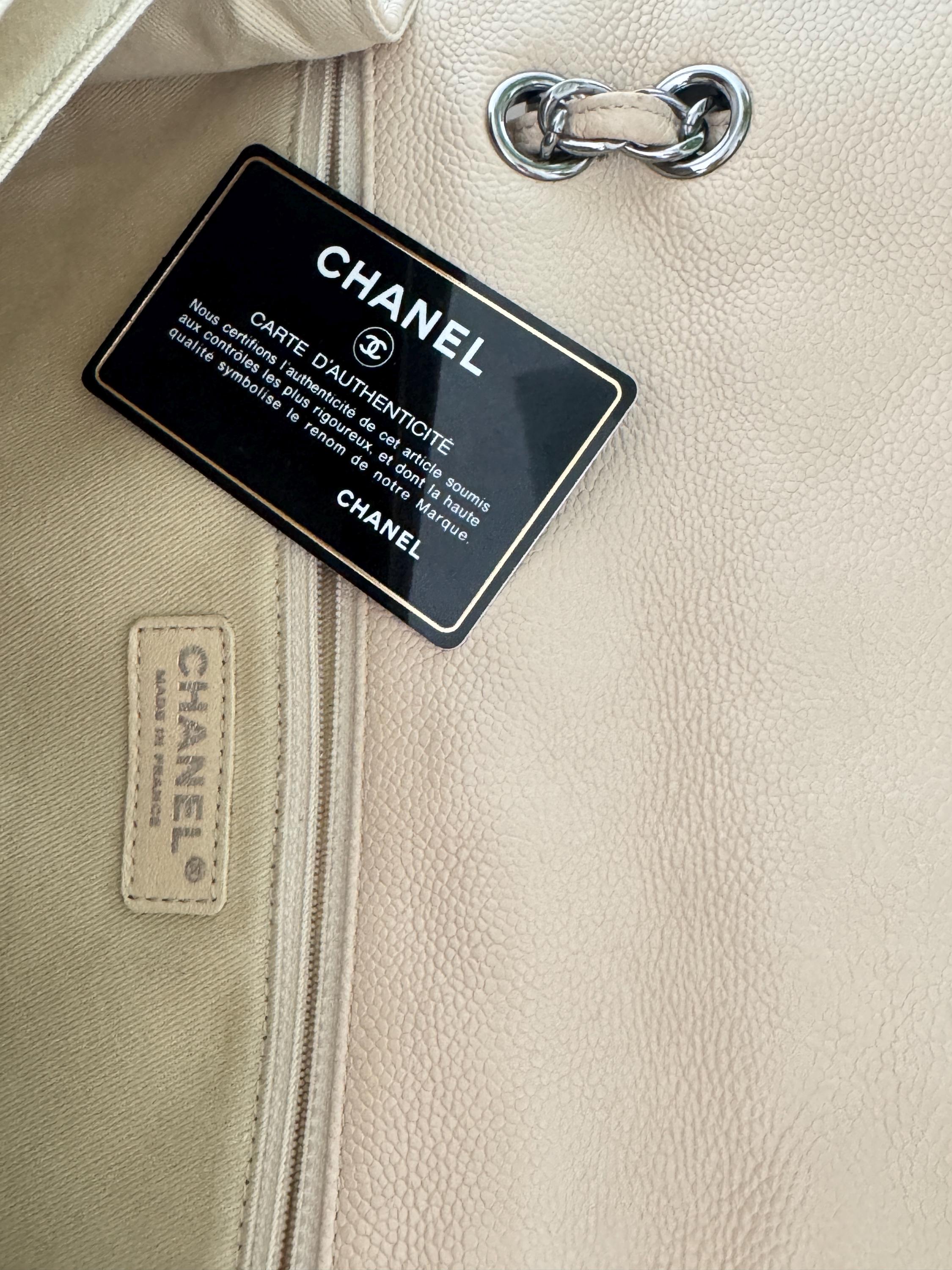 Vintage classic Chanel shoulder bag in caviar beige, made in France, with large front pockets, luxury designer handbag