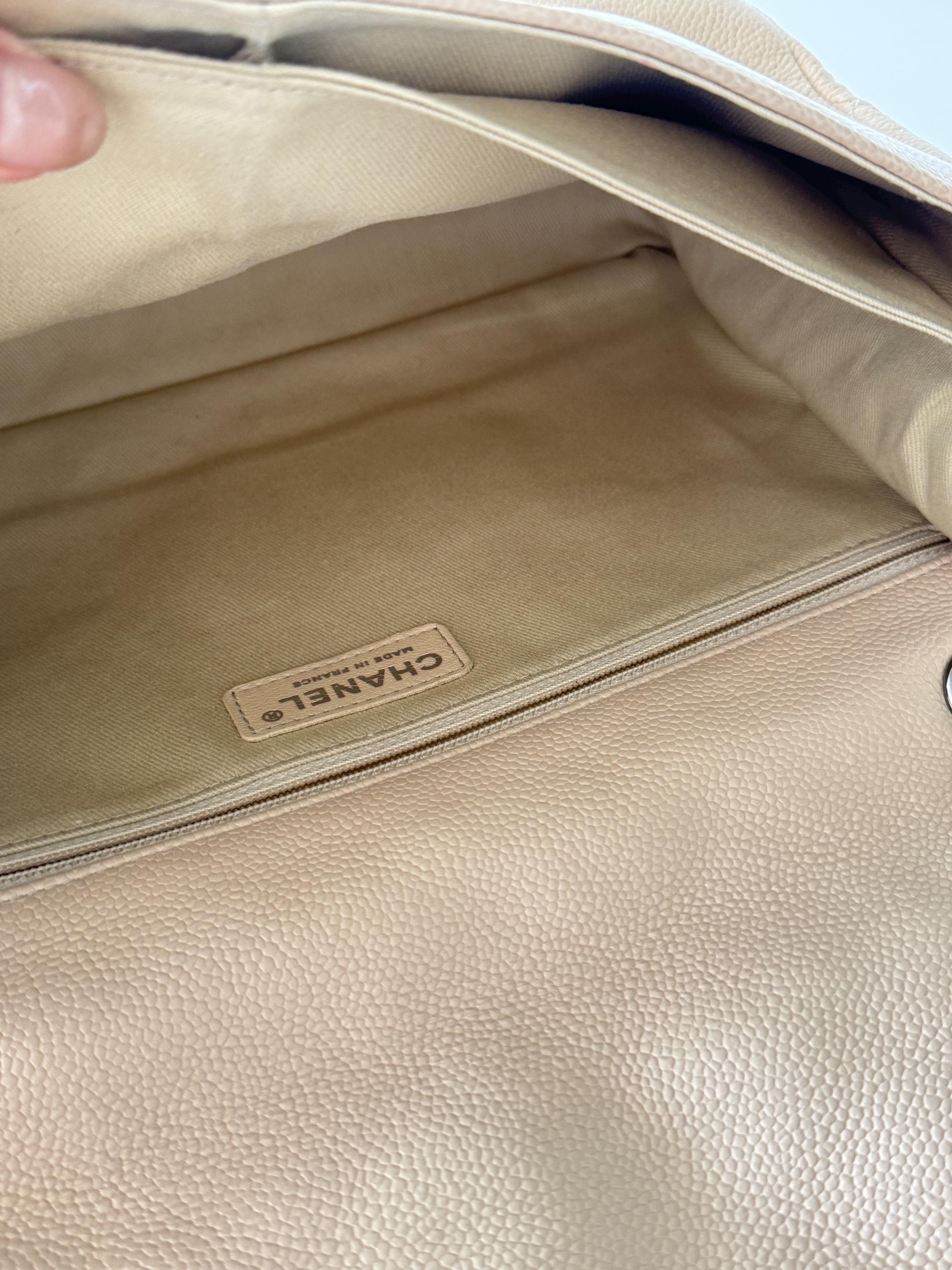Vintage classic Chanel shoulder bag in caviar beige, made in France, with large front pockets, luxury designer handbag
