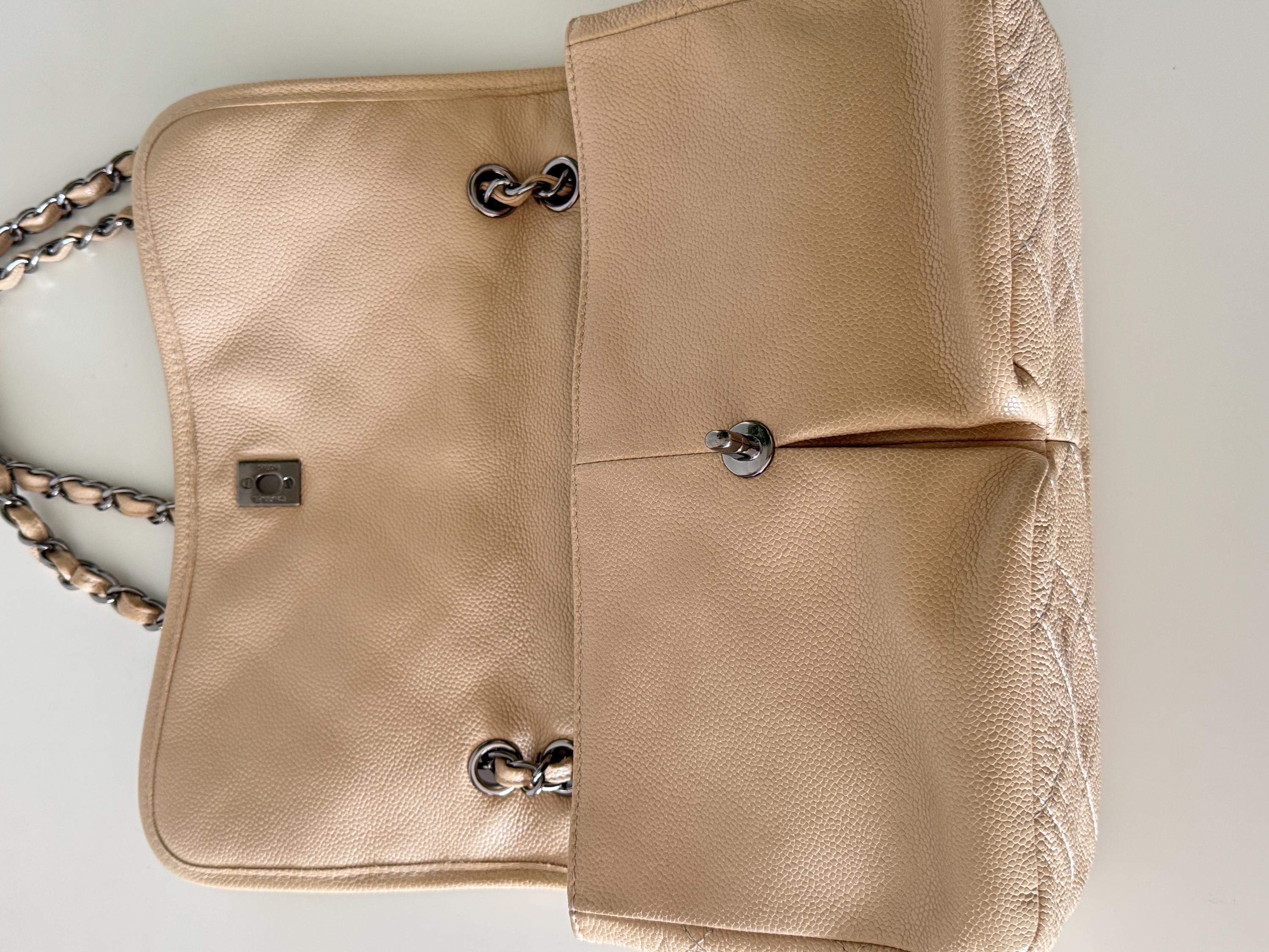 Vintage classic Chanel shoulder bag in caviar beige, made in France, with large front pockets, luxury designer handbag