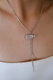 Elegant vintage Christian Dior designer necklace, silver tone logo charm jewelry from the Galliano era, timeless luxury accessory for women