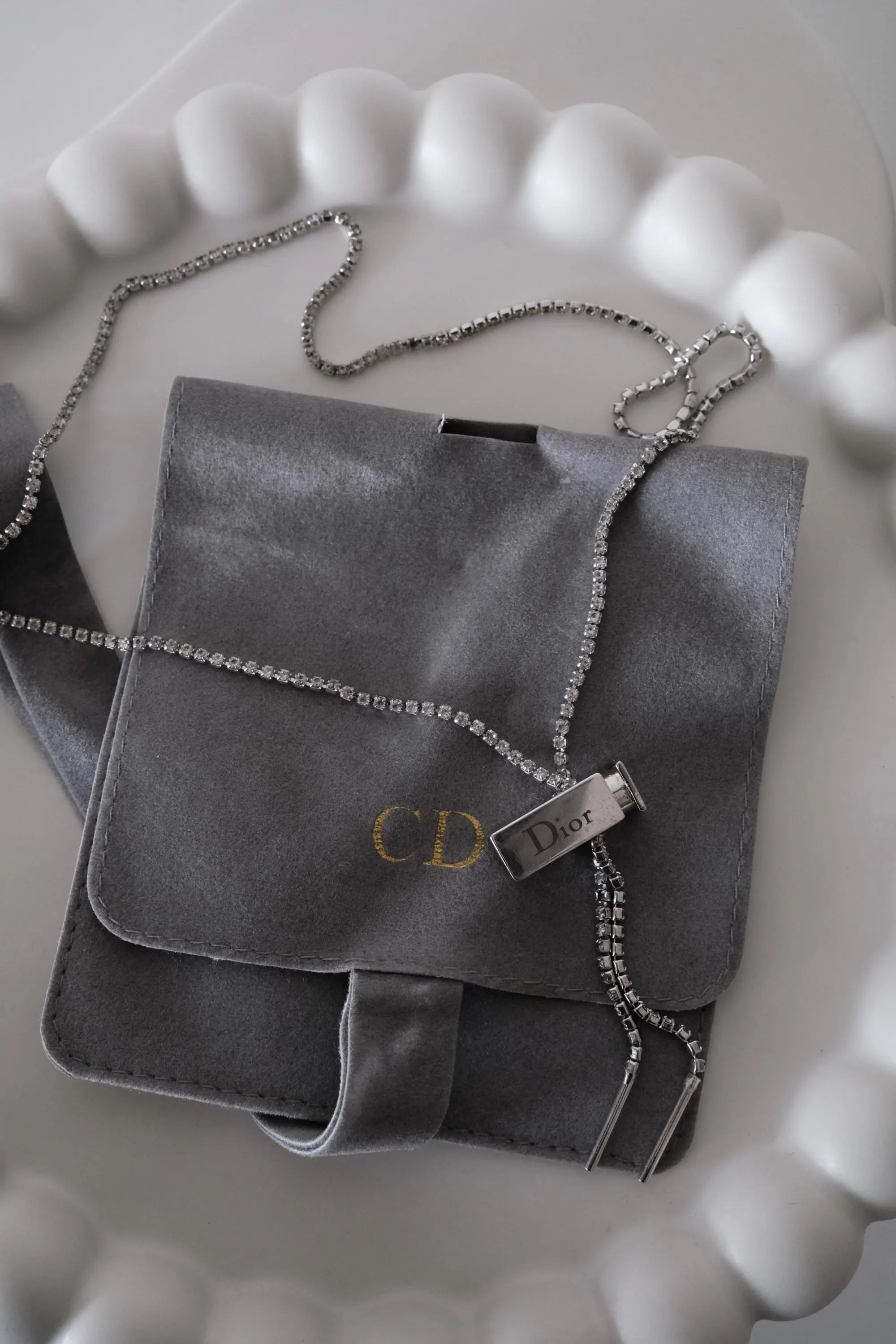 Elegant vintage Christian Dior designer necklace, silver tone logo charm jewelry from the Galliano era, timeless luxury accessory for women