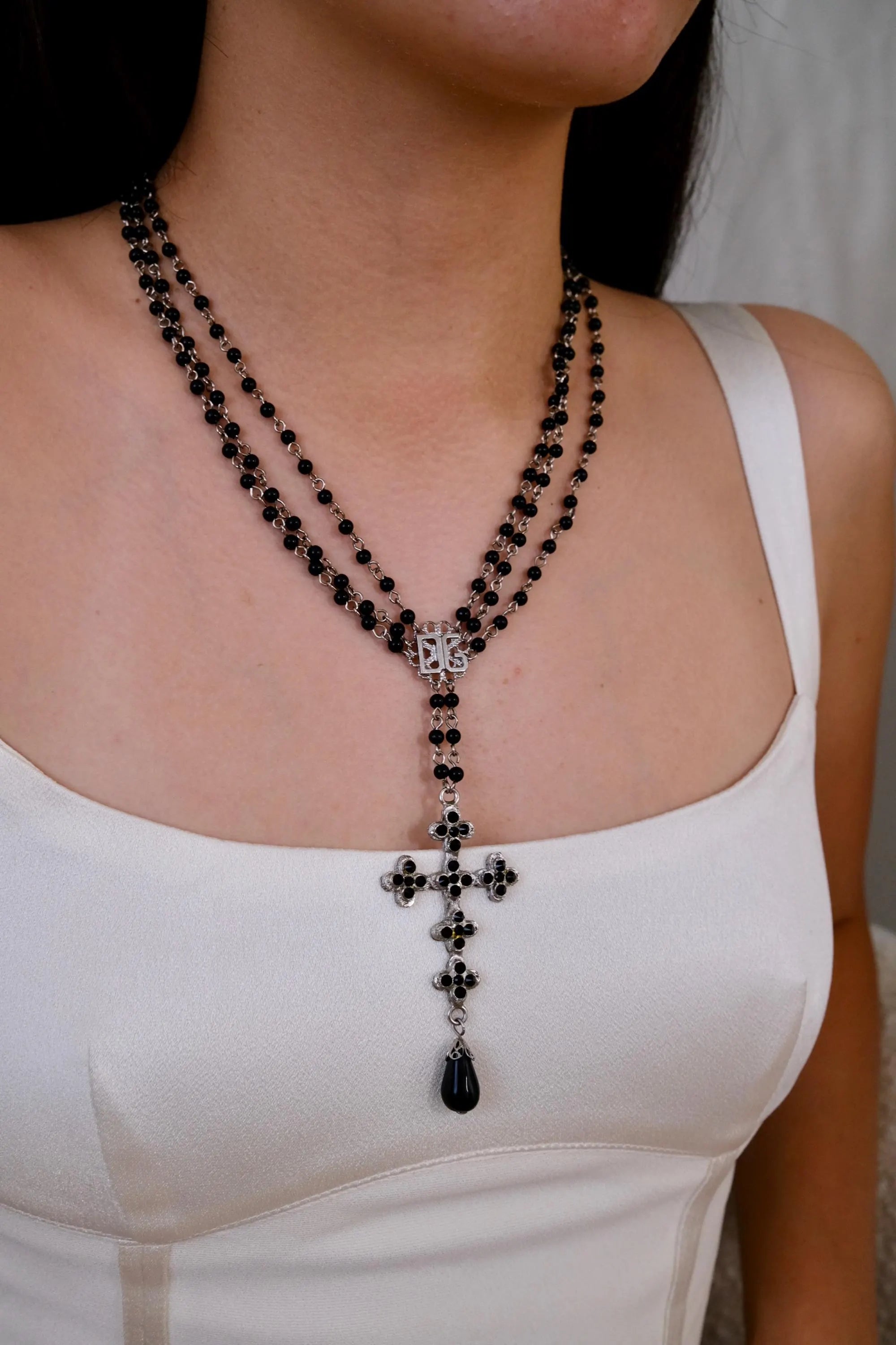 Vintage Dolce & Gabbana cross necklace with black beads, timeless luxury accessory