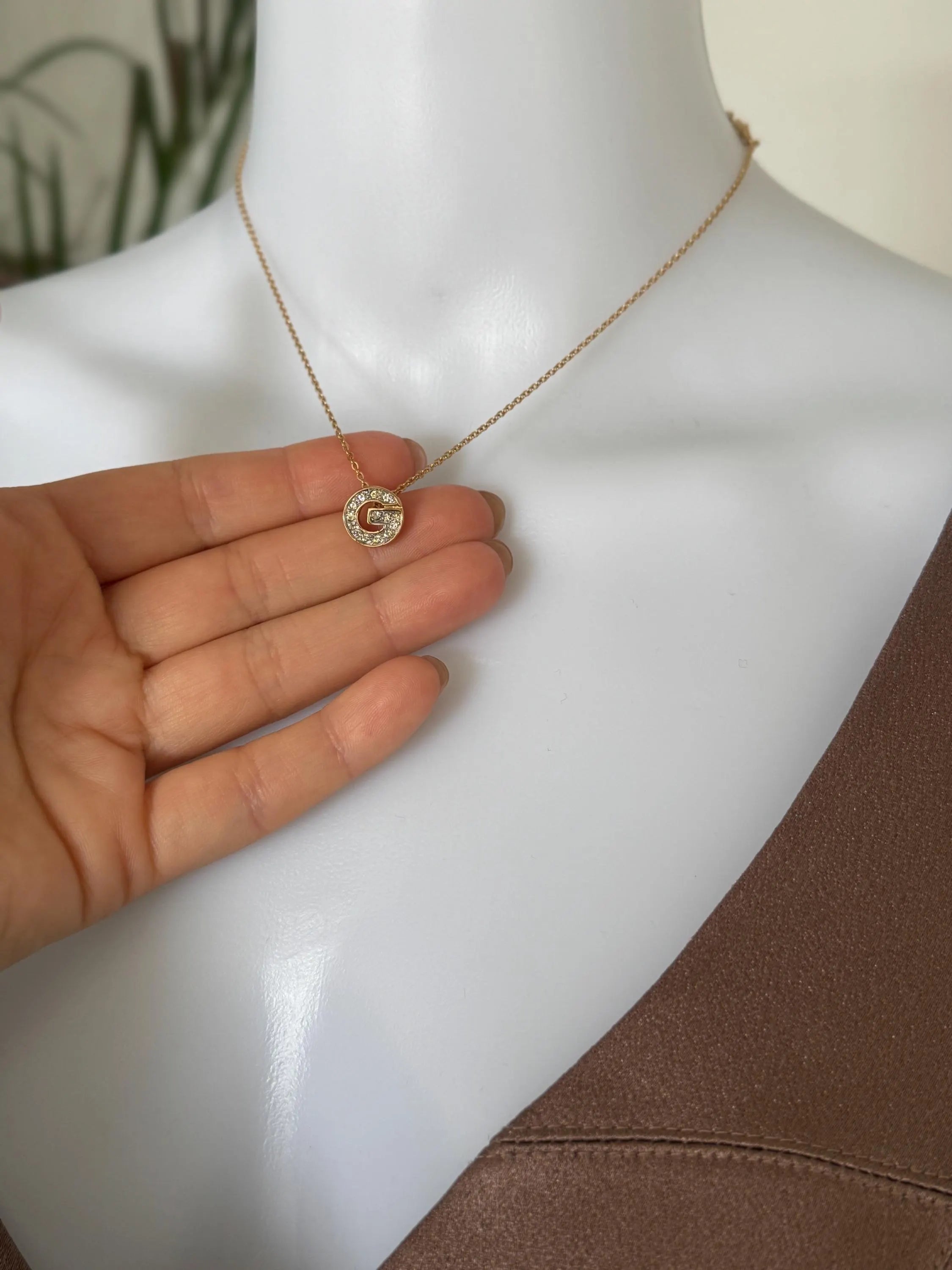 Vintage Givenchy gold tone G logo necklace and earrings set with crystal rhinestones