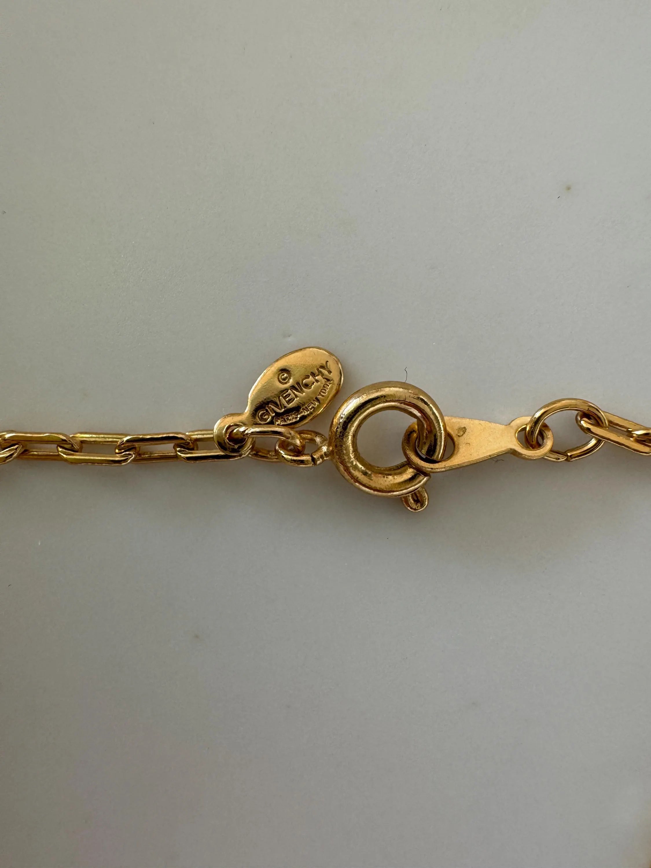 Elegant vintage Givenchy choker necklace in gold tone, iconic G logo and timeless European designer style