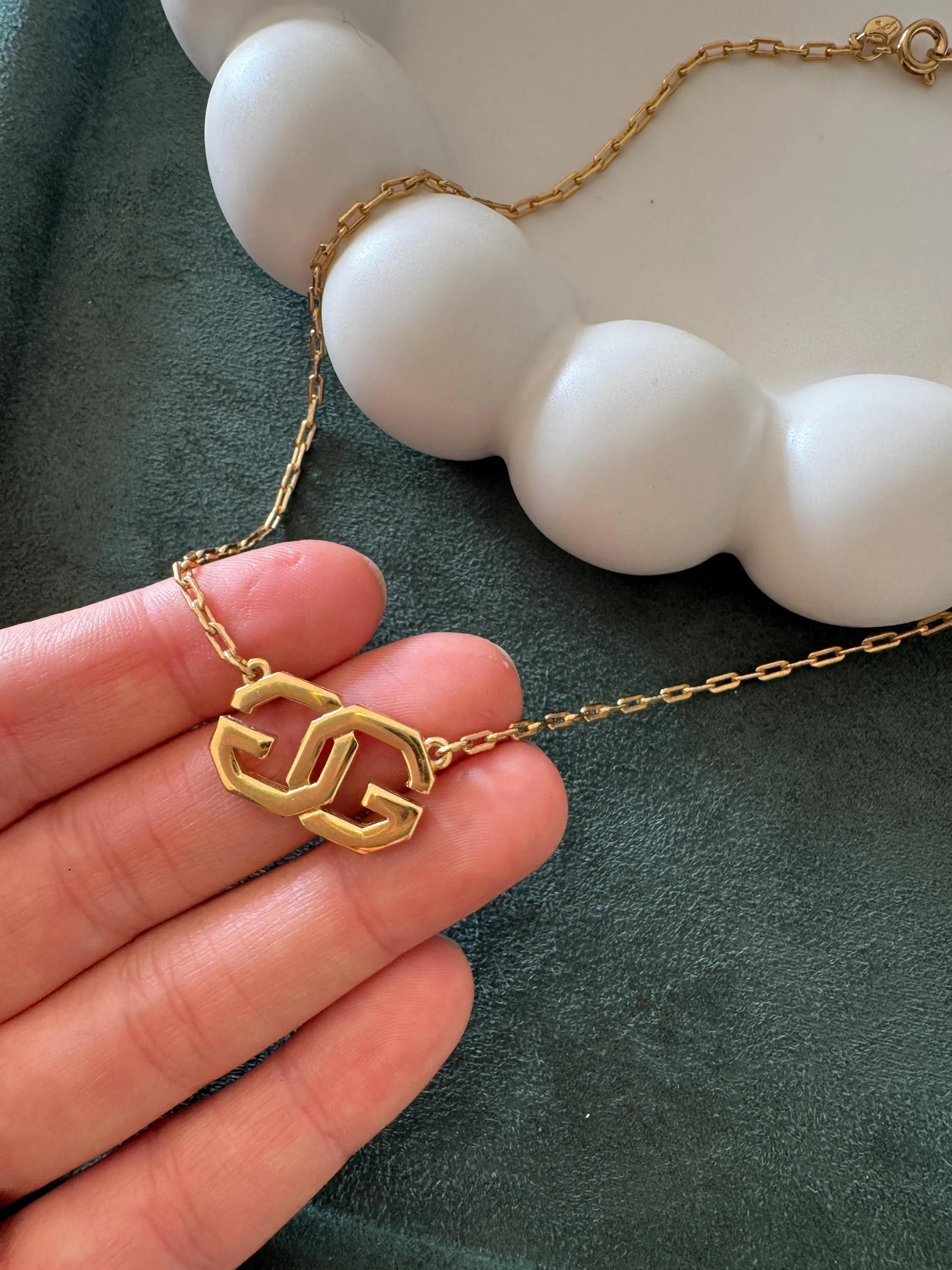 Elegant vintage Givenchy choker necklace in gold tone, iconic G logo and timeless European designer style