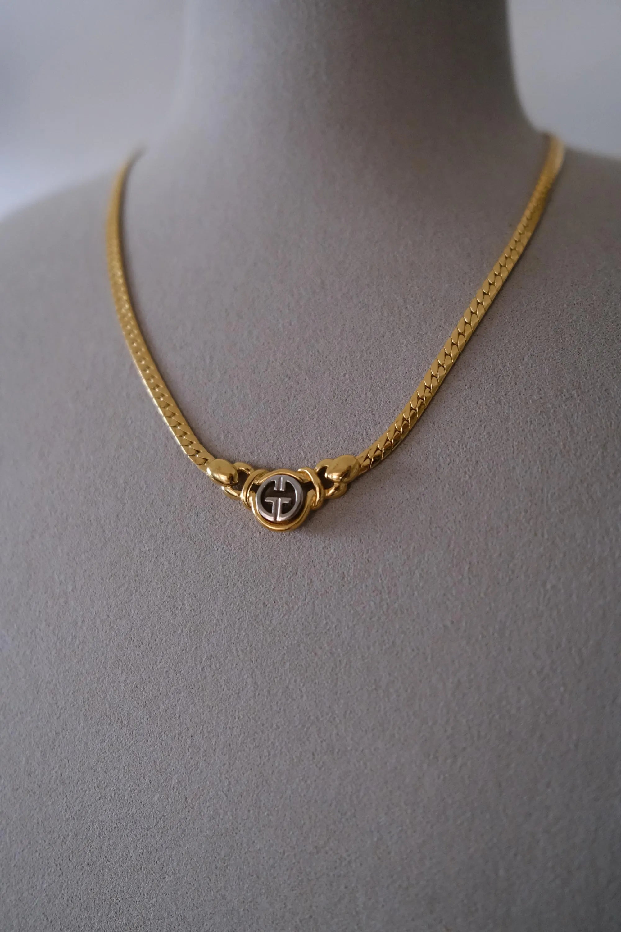 Vintage Givenchy logo choker necklace styled at the décolletage
