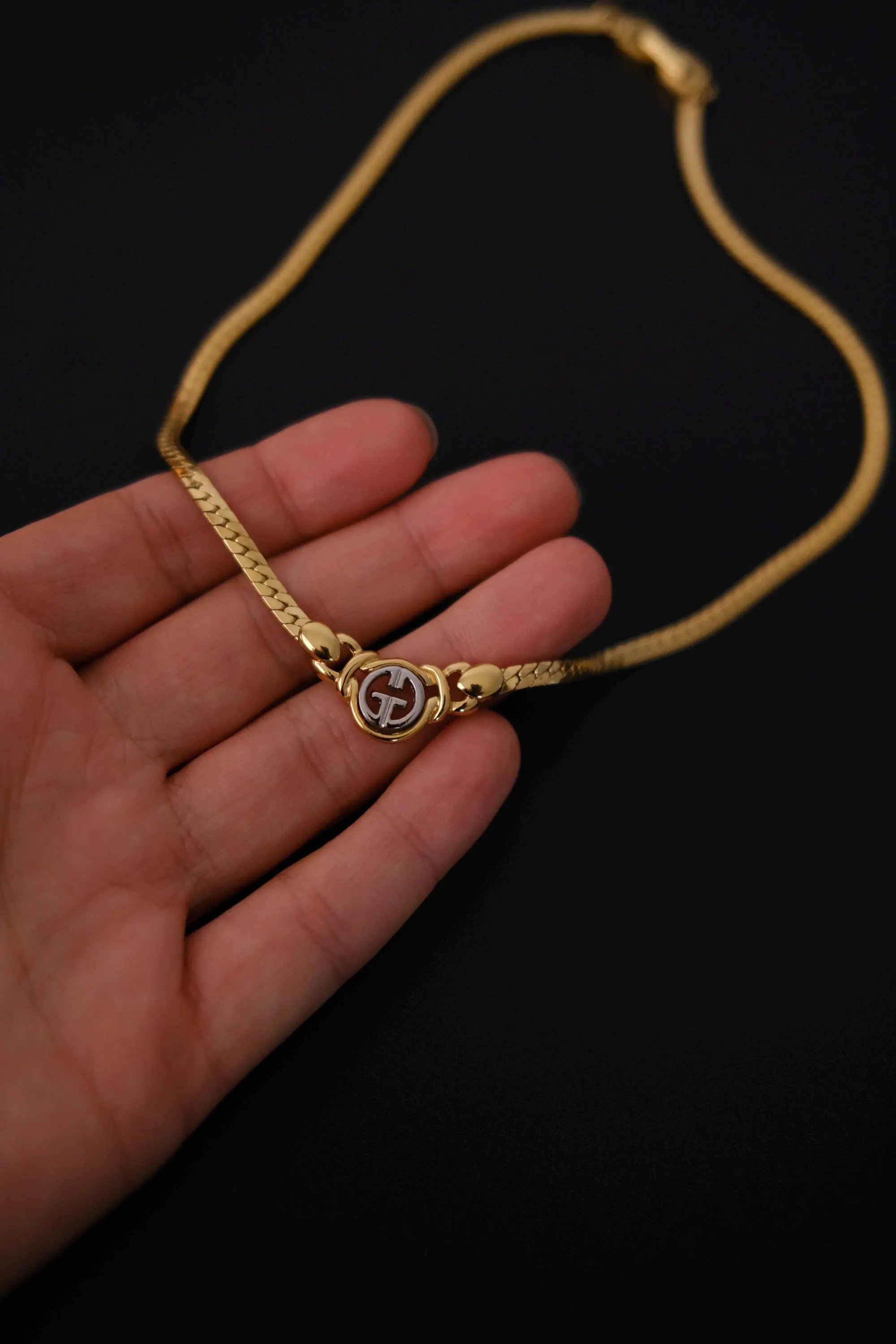 Givenchy vintage gold-tone logo charm close-up detail