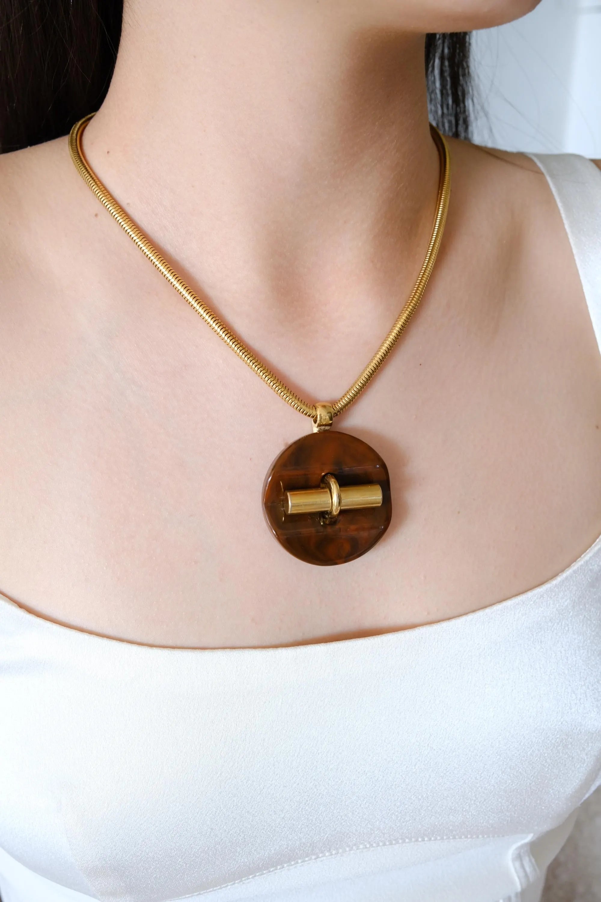 Vintage Givenchy gold tone snake chain necklace with sculptural pendant, elegant designer fashion jewelry and timeless luxury gift for women