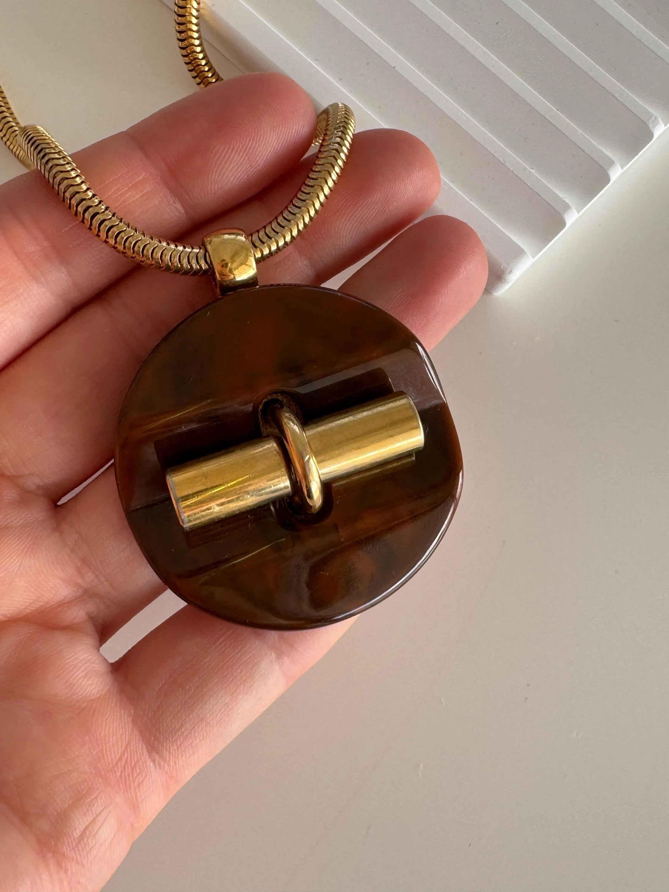Elegant vintage Givenchy designer necklace, gold tone snake chain with sculptural pendant, refined luxury jewelry for women