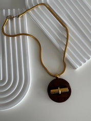 Elegant vintage Givenchy designer necklace, gold tone snake chain with sculptural pendant, refined luxury jewelry for women