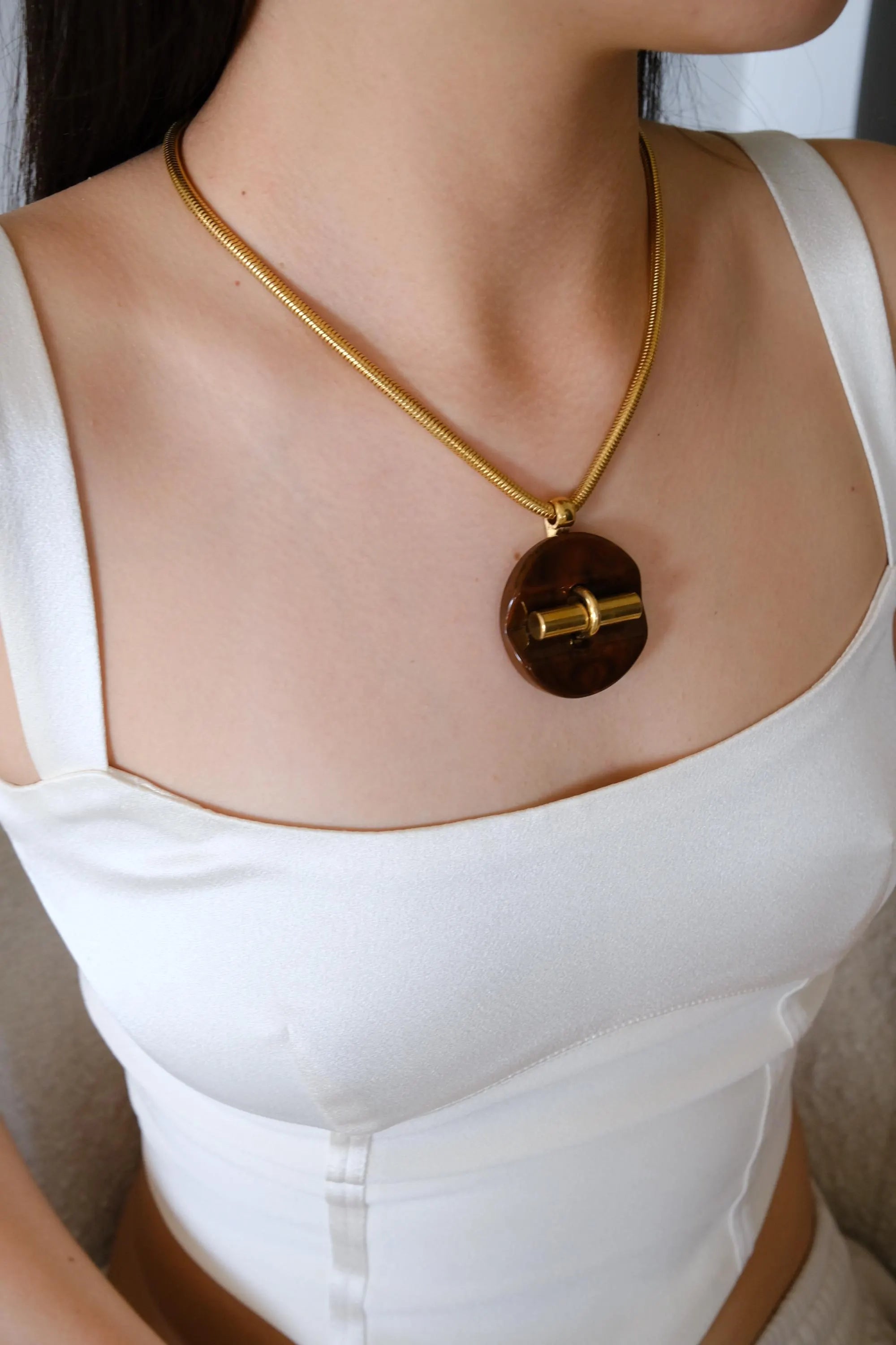 Vintage Givenchy designer necklace in gold tone snake chain, sophisticated statement pendant jewelry, perfect luxury gift for women