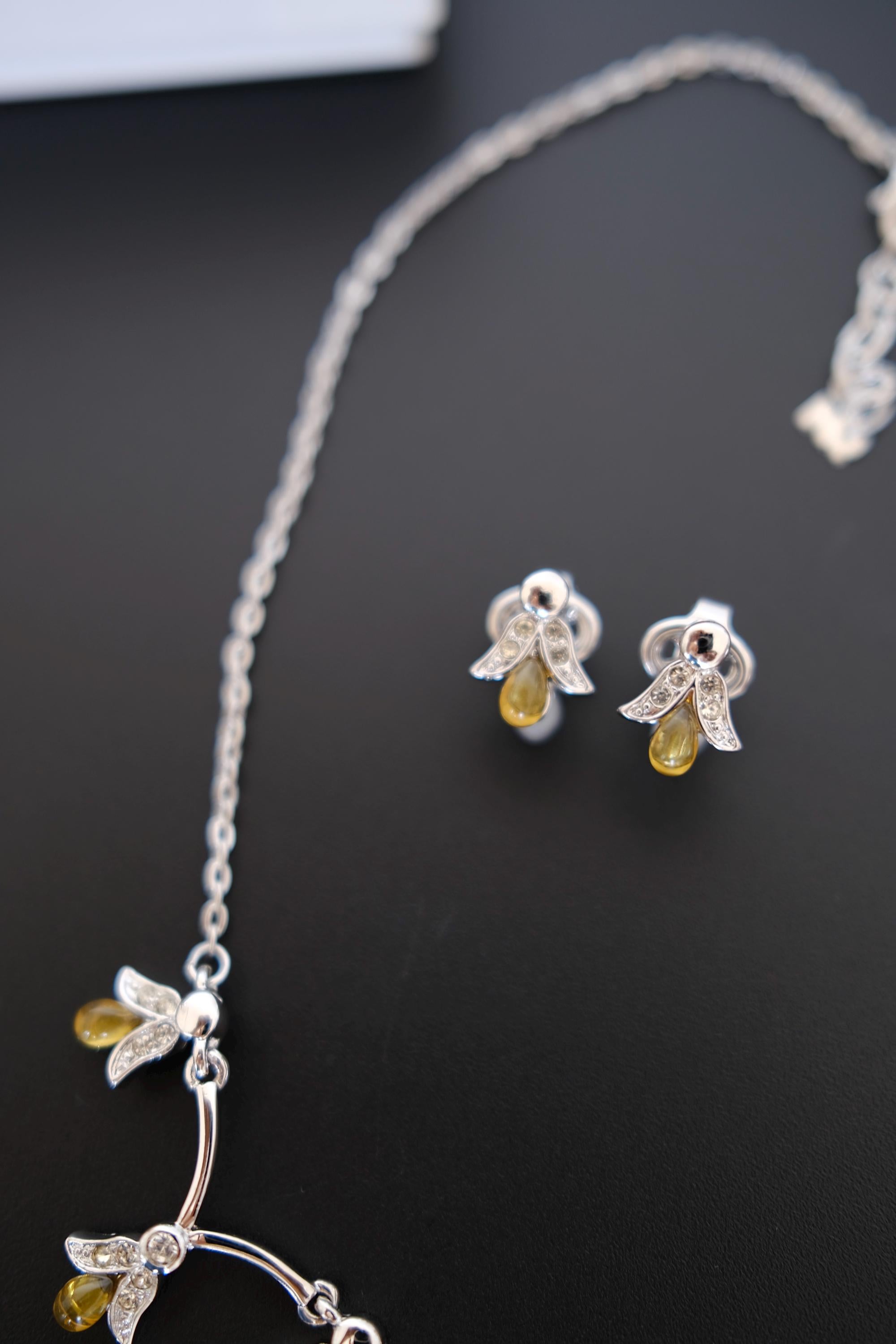 Vintage Nina Ricci delicate curved branch and floral-inspired silver-tone jewelry detail