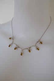 Vintage Nina Ricci amber glass and crystal floral necklace worn around the neck