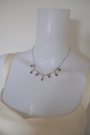 Vintage Nina Ricci amber glass and crystal floral necklace worn around the neck