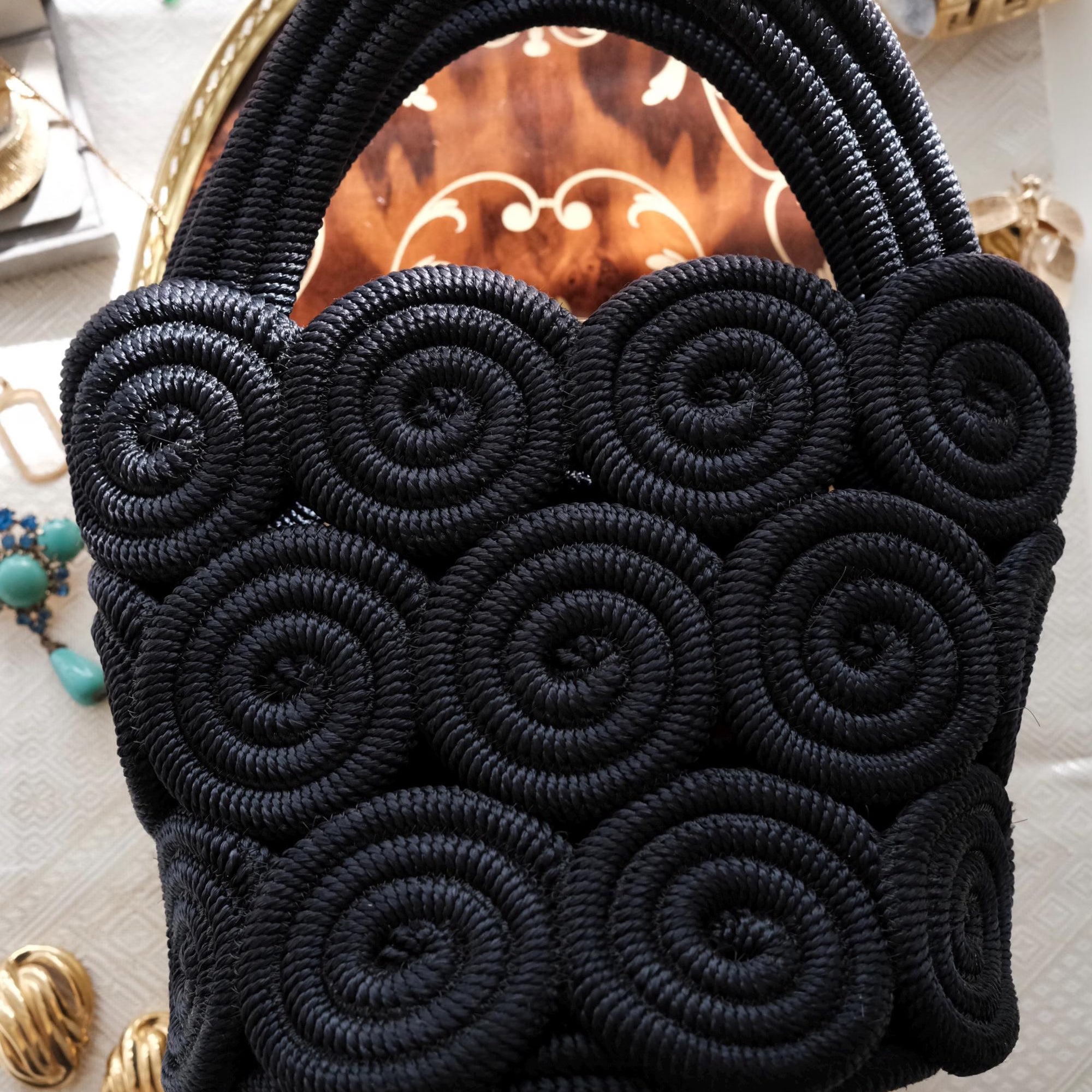 Vintage Nina Ricci handcrafted rope handbag, sculptural black design showcasing refined French craftsmanship