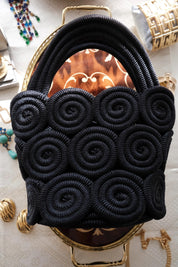 Vintage Nina Ricci handcrafted rope handbag, sculptural black design showcasing refined French craftsmanship