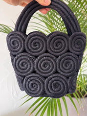 Vintage Nina Ricci handcrafted rope handbag, sculptural black design showcasing refined French craftsmanship