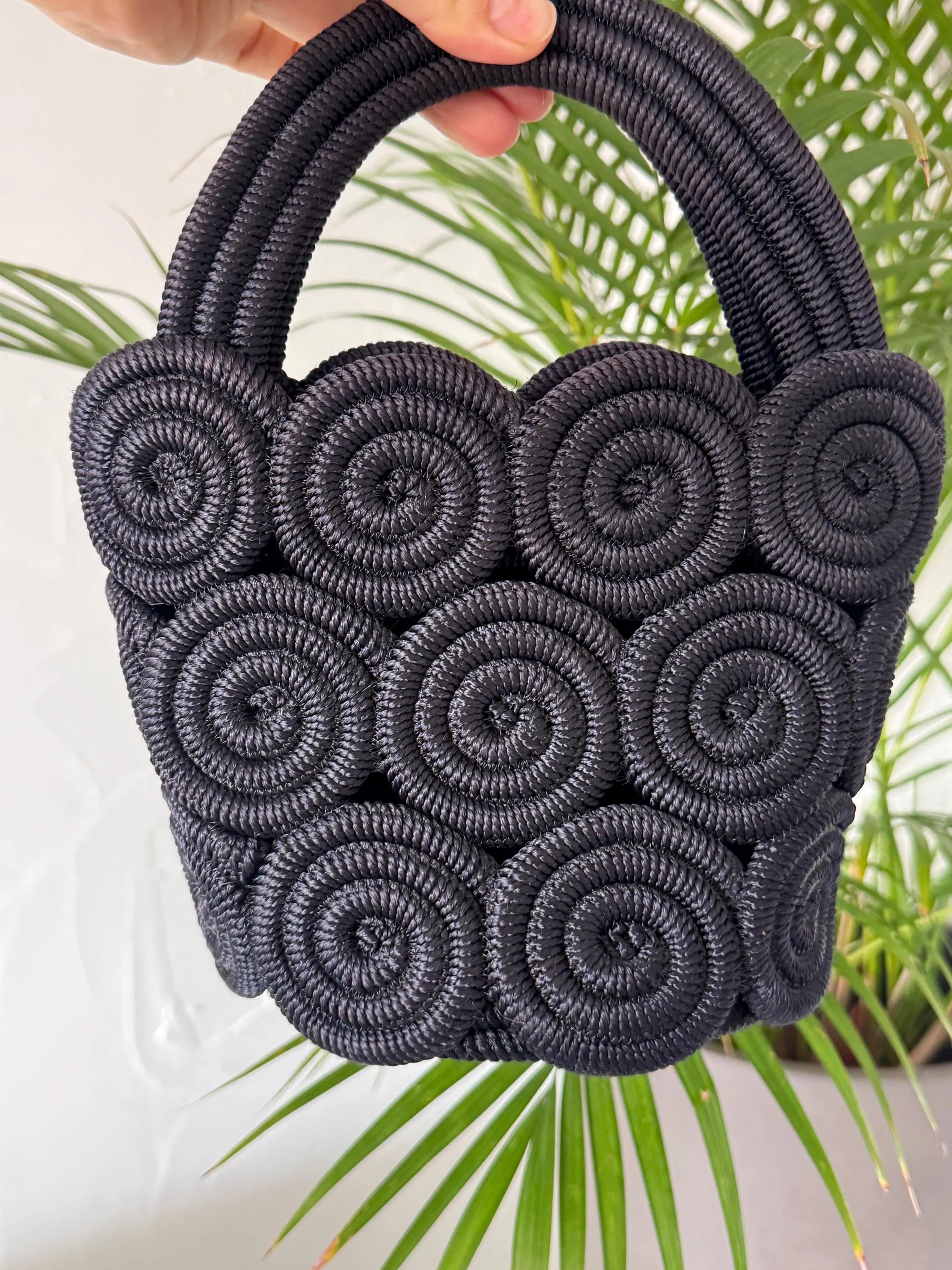 Vintage Nina Ricci handcrafted rope handbag, sculptural black design showcasing refined French craftsmanship